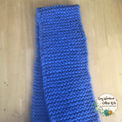 a blue hand knitted chunky scarf