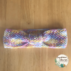 a teenagers hand knitted frosting bow headband