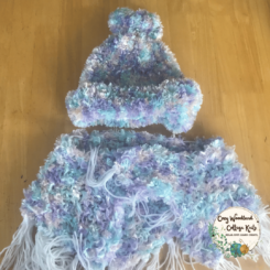 a teenagers shawl and slouchy beanie set knitted with feathered yarn