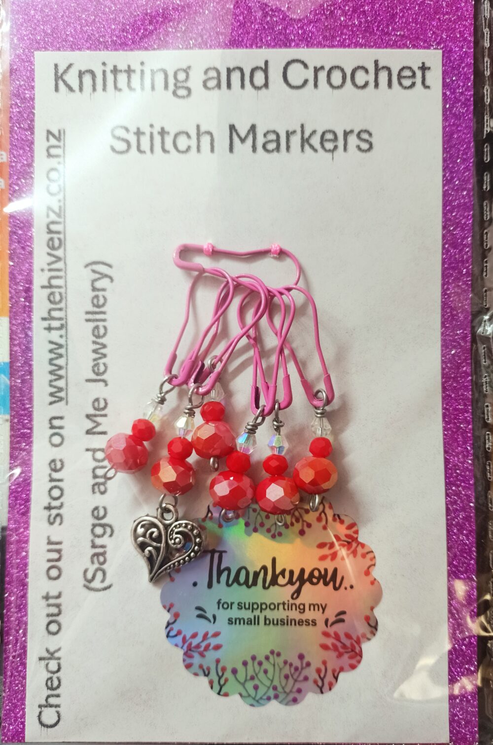 red knitting or crochet stitch markers