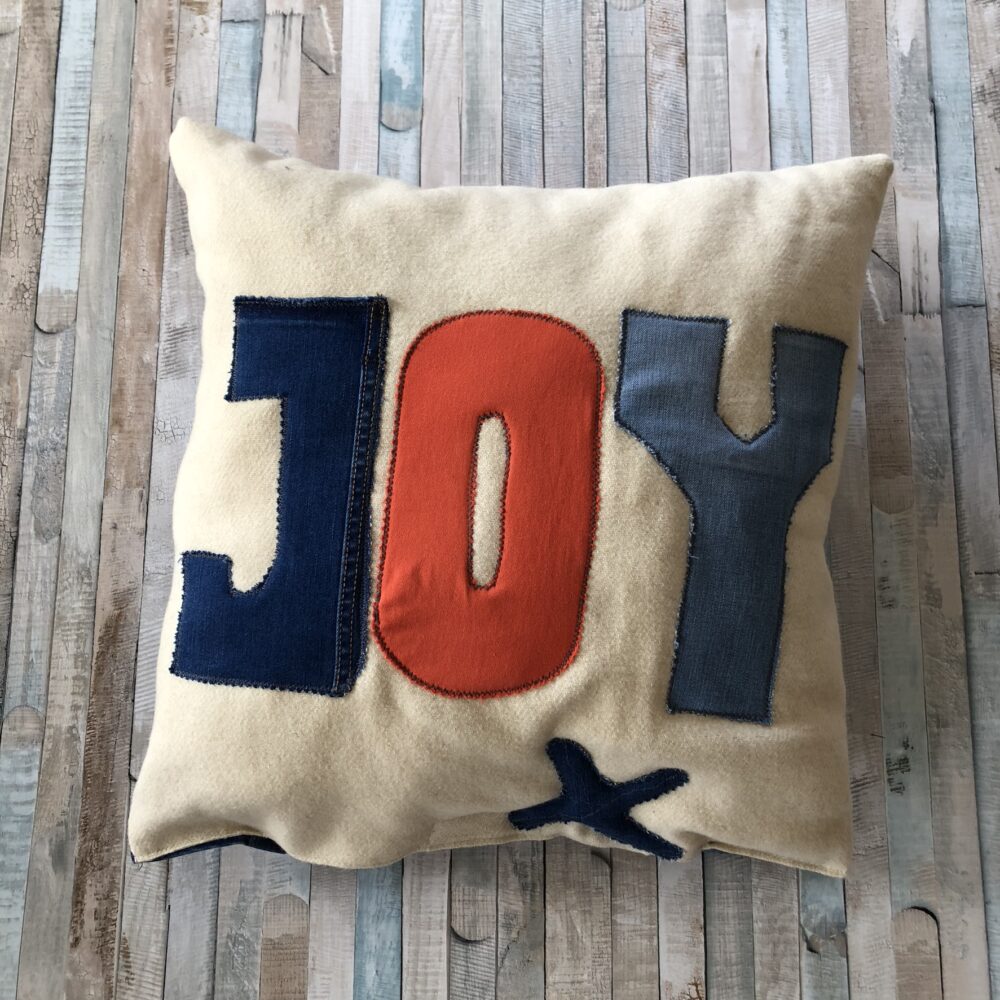 Handmade cushion from pre-loved denim and woolen blankets