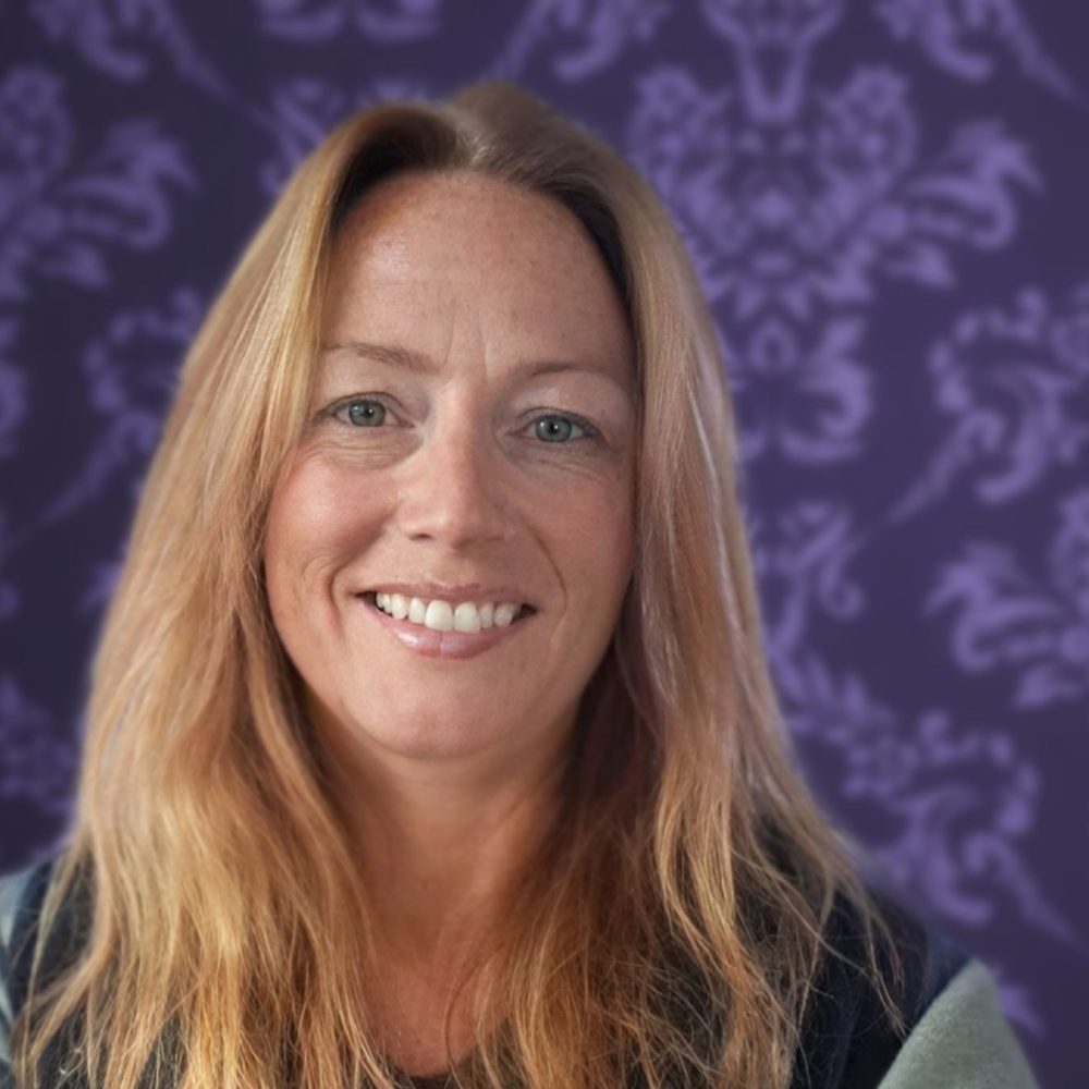 Kolet, the founder of The Hive NZ, smiling in a professional setting.